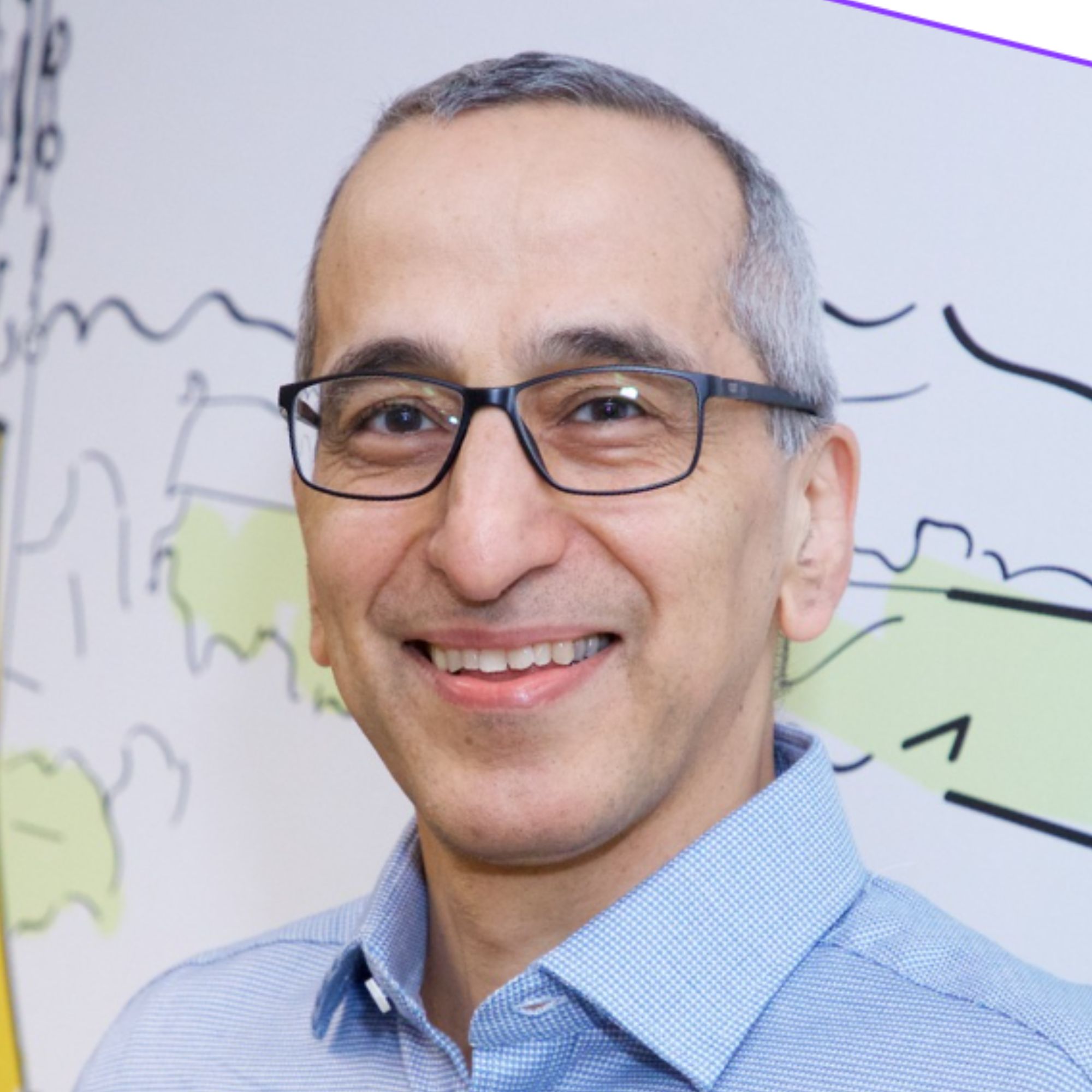 A headshot of a man in a blue shirt 