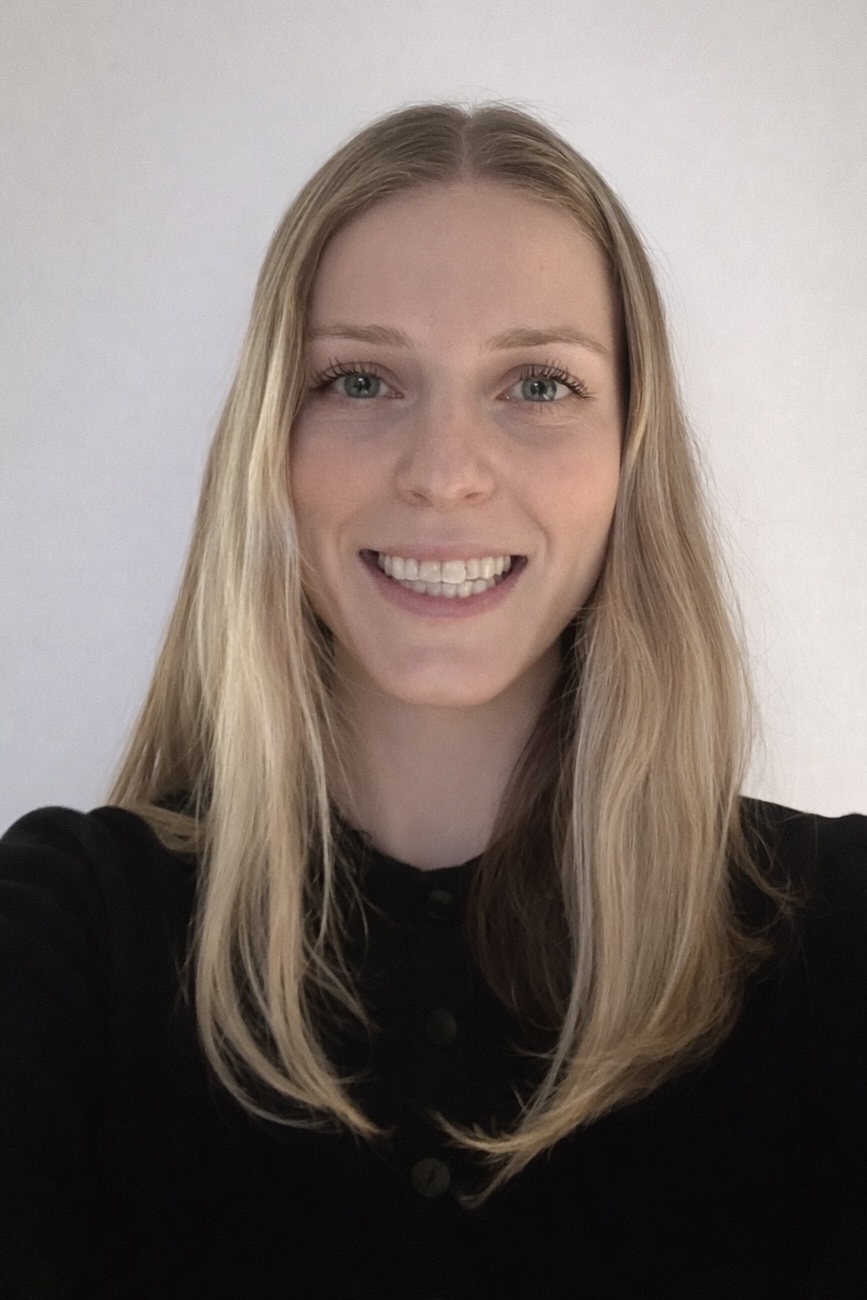Headshot of a woman with blonde hair wearing a black shirt