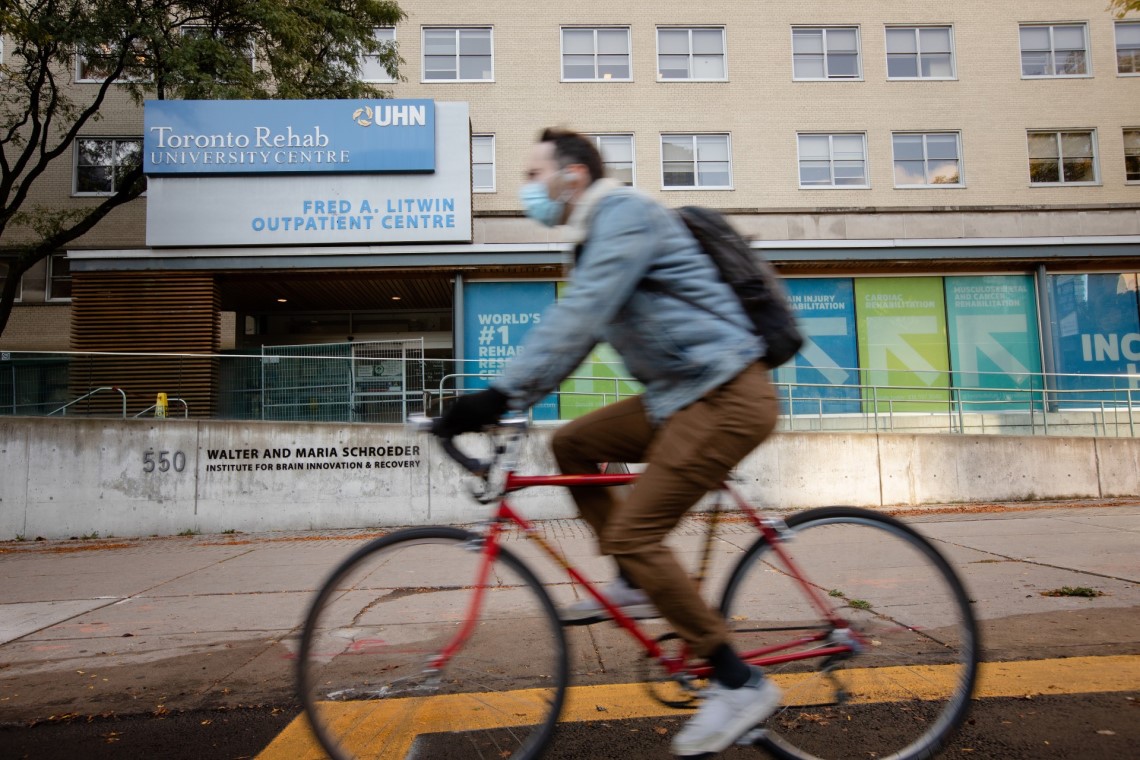 Cyclist outside the Toronto Rehab University Centre at UHN in Toronto